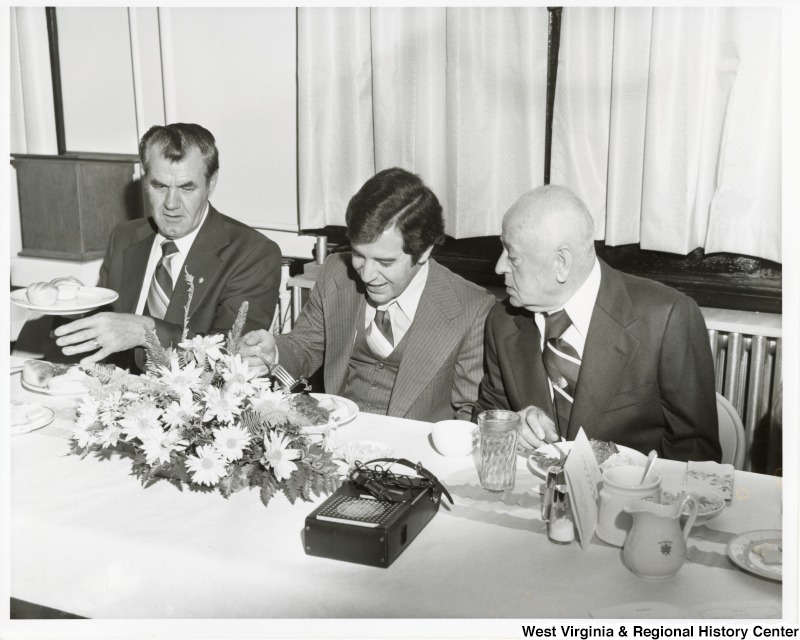 Congressman Nick Rahall II (Center) eating breakfast with two unidentified men from Williamson, West Virginia.