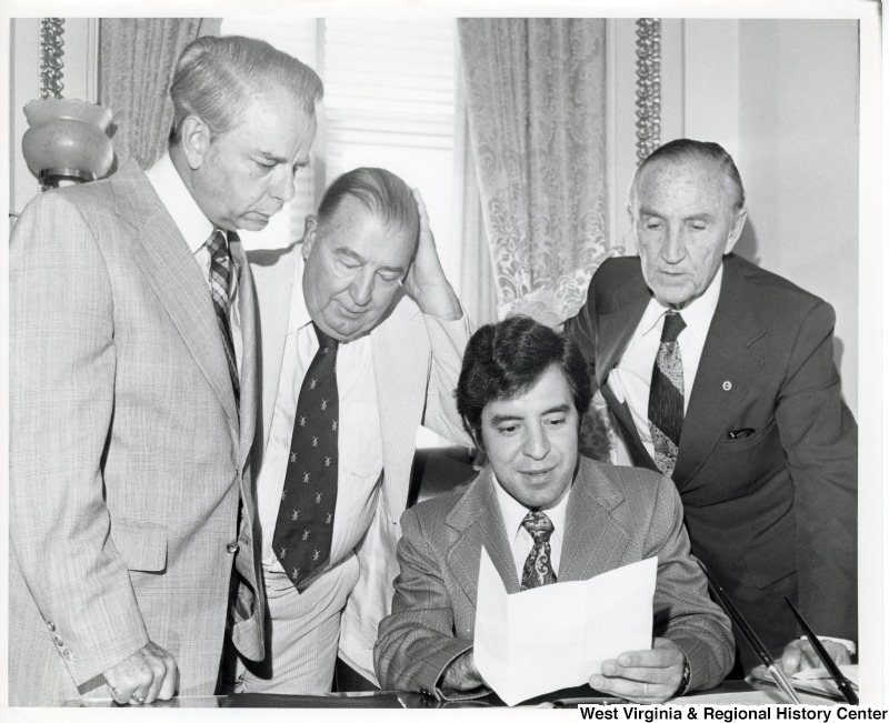 From left to right: Senator Robert C. Byrd, Senator Jennings Randolph, Congressman Nick Rahall II (seated) and Senate Majority Leader Mike Mansfield.