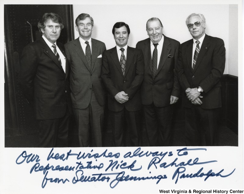 From left to right: an unidentified man, Congressman Cleve Benedict, Congressman Nick Rahall II, Senator Jennings Randolph and an unidentified man. The photograph is signed "Our best wishes always to Representative Nick Rahall from Senator Jennings Randolph."