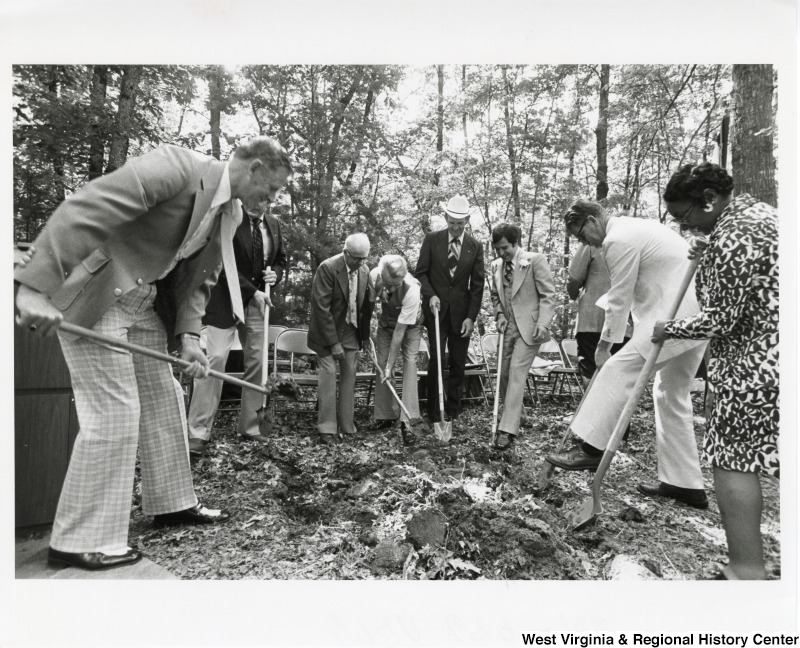 Congressman Nick Rahall II (right of center) and Senator Robert C. Byrd (left of center) with six unidentified people digging up the ground.