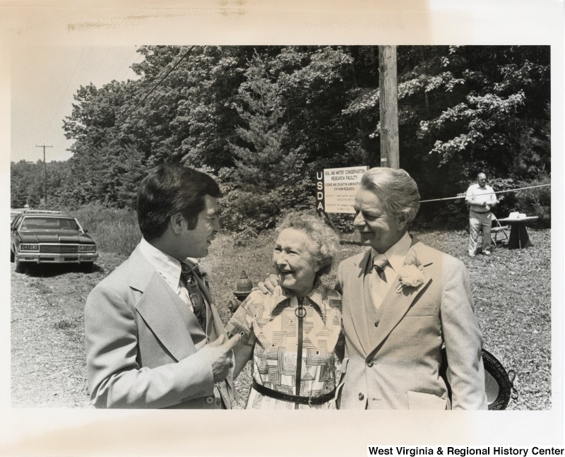 Congressman Nick Rahall II speaking with Margaret Phipps and Senator Robert C. Byrd. Margaret Phipps was Rahall's 3rd grade teacher at Institute Elementary School. She was also a friend of Byrd's from his days as a butcher in Sophia, WV. Byrd has his arm around Margaret.