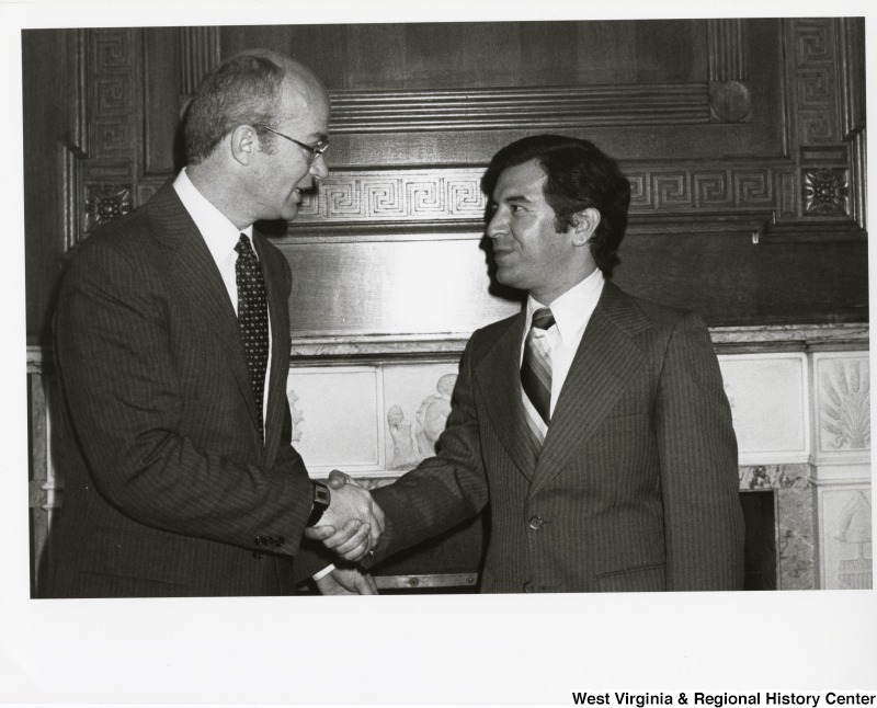 Congressman Nick Rahall II shaking the hand of an unidentified man