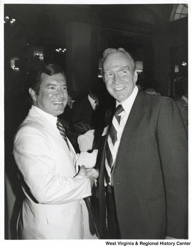 Congressman Nick Rahall (D-WV) shaking Congressman Jim Wright's (D-TX) hand.