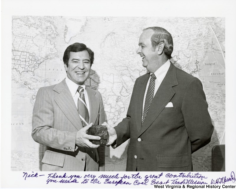Congressman Nick Rahall II with Assistant Secretary for Trade Development in Department of Commerce, William Morris, Jr, upon his return from Spain, Italy, and France for a U.S. coal export mission. The photograph is signed 'Nick - Thank you very much for the great contribution you made to the European coal export trade mission. W. H. Morris, Jr.'