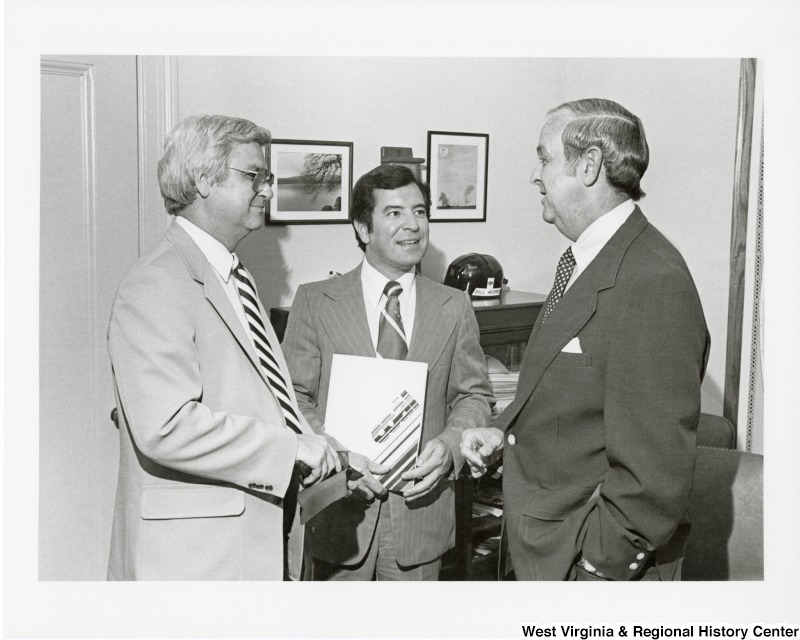 From left to right: an unidentified man, Congressman Nick Rahall II, and William Morris, Jr., Assistant Secretary for Trade Development in Department of Commerce.