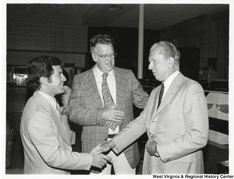From left to right: Congressman Nick Rahall II (D-WV); Herb, new House gym?, and Senator Robert Stafford (R-UT). Congressman Rahall is shaking the hand of Senator Stafford. They are at a House