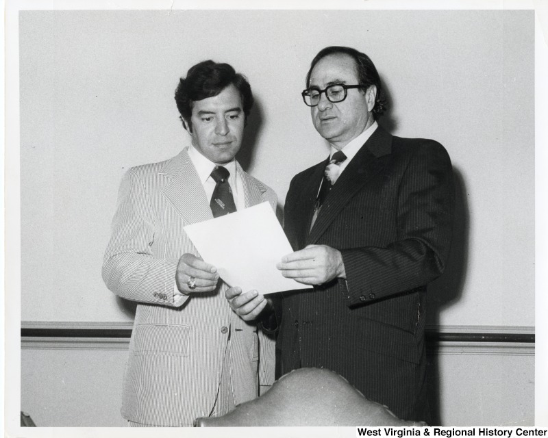 Congressman Nick Rahall II (D-WV) and Senator James Abourezk (D-SD). They are looking at a document that Abourezk is holding. Abourezk's father was from the same village in Lebanon as Rahall's grandfather.