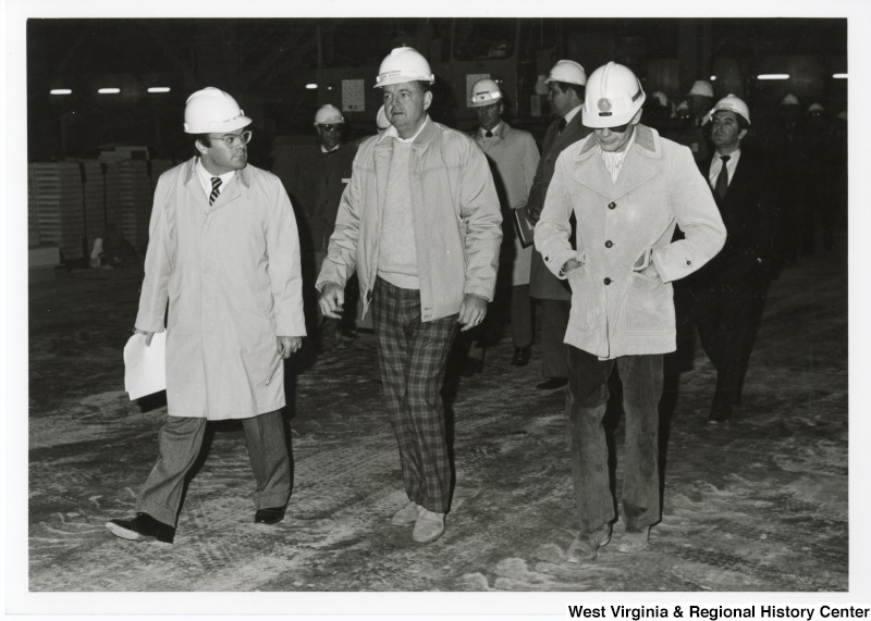 Congressman Michael Myers (D-PA), center, walking with two unidentified people during a tour of the Stone and Webster Engineering Corporation.