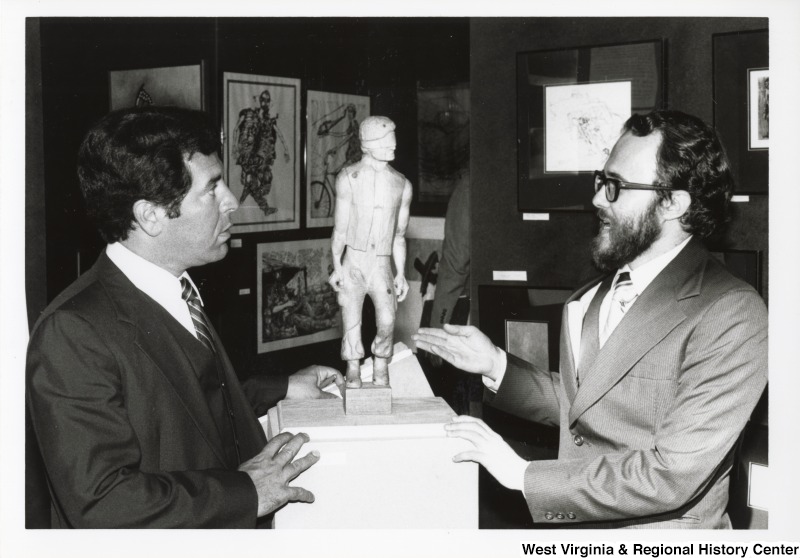 Congressman Nick Rahall II looking at a sculpture with an unidentified man.