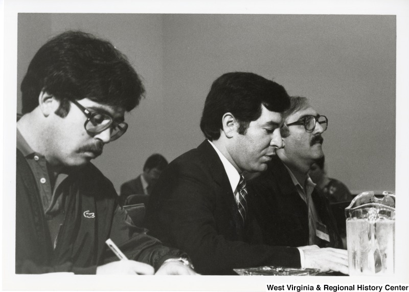 Congressman Nick Rahall II (center) sitting with two unidentified men.