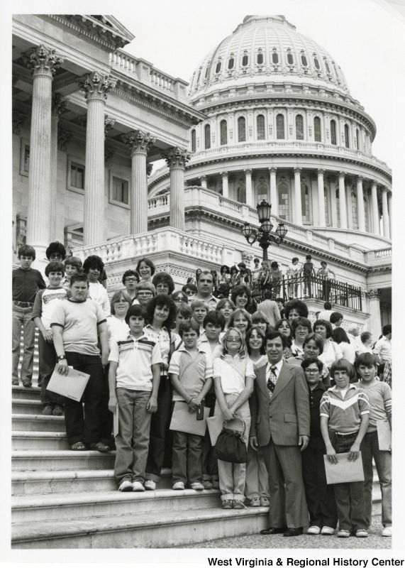 Congressman Nick Rahall II with a unidentified group of school children on the steps of the Capitol complex.