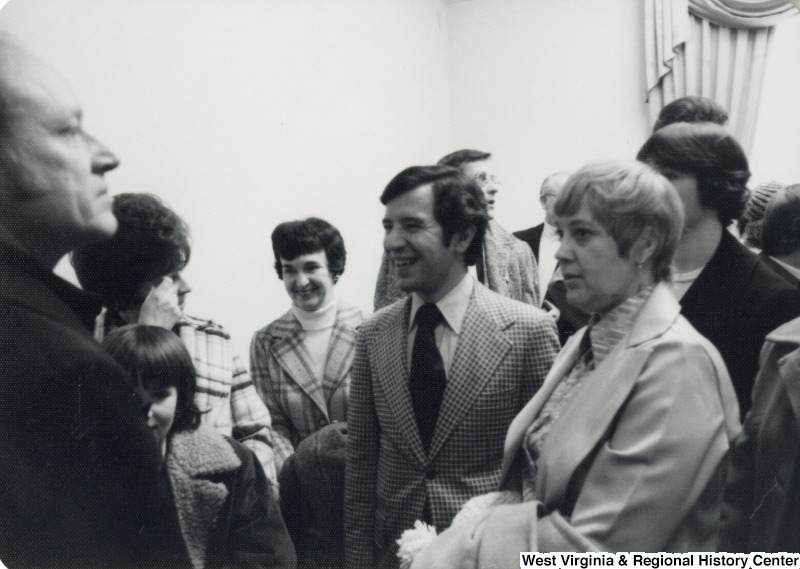 Congressman Nick Rahall II (center) surrounded by a unidentified group of people.