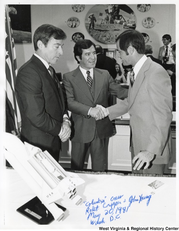 Congressman Nick Rahall II shaking the hand of Robert Crippen the pilot for the first flight with Space Shuttle Columbia (STS-1). John Young, commander of the Columbia crew, is standing beside Rahall.