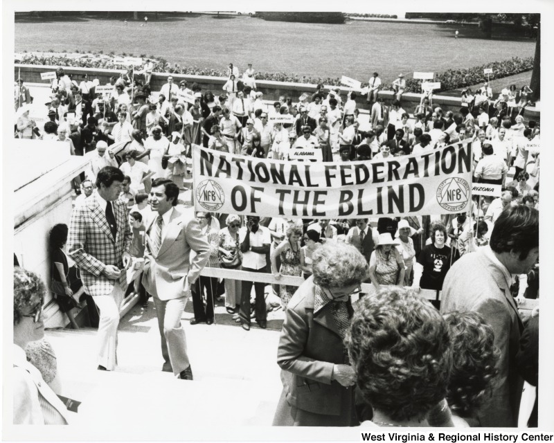 Congressman Nick Rahall II with a large group of people from the National Federation of the Blind (NFB).