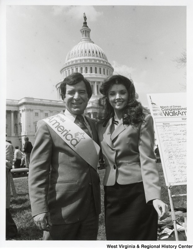 Congressman Nick Rahall II with an unidentified woman at the March of Dimes Congressional WalkAmerica event. The U.S. Capitol Complex can be seen behind them.