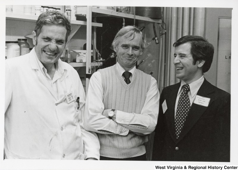 Congressman Nick Rahall II (first on the right) laughing with two unidentified men.