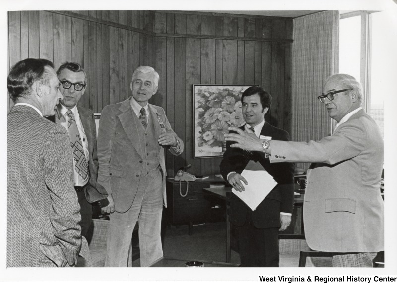 Congressman Nick Rahall II (second from the left) talking with four unidentified men.