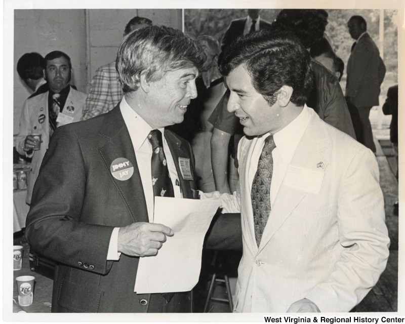 Congressman Nick Rahall speaking to an unidentified man wearing a Jimmy/ Jay button.