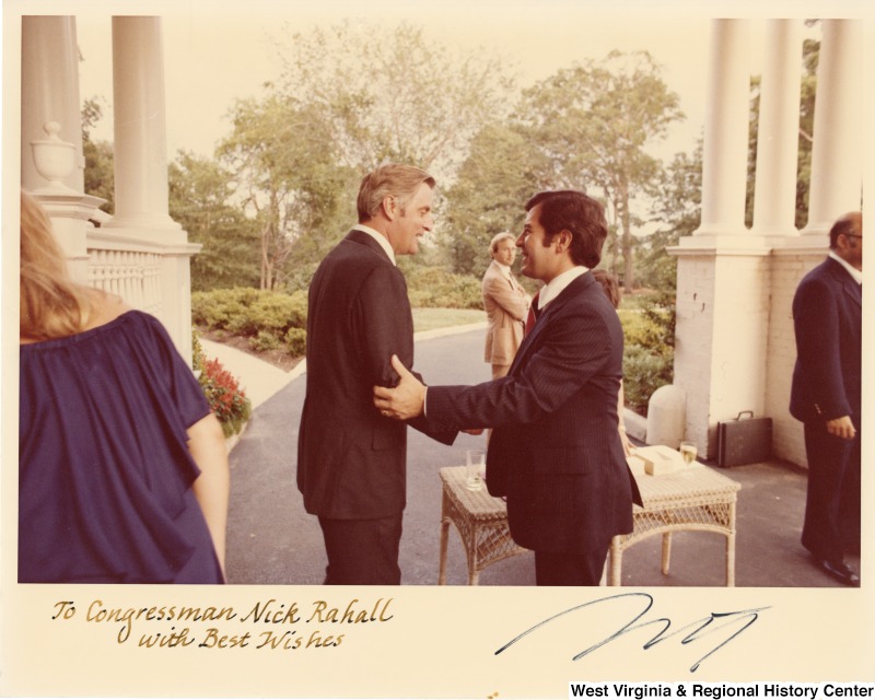 Vice President Walter Mondale and Congressman Nick Rahall shaking hands. They are at Vice-President Mondale's house. Photograph is signed: "To Congressman Nick Rahall with best wishes."