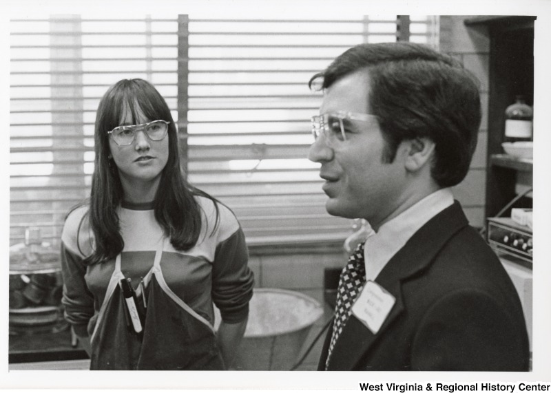 Congressman Nick Rahall II speaking with an unidentified woman.