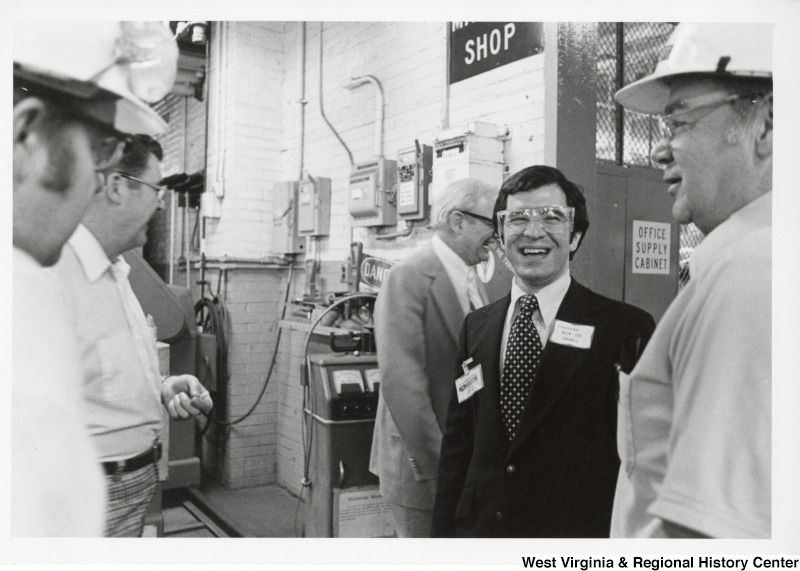 Congressman Nick Rahall II (second from right) speaking with four unidentified Union Carbide employees.