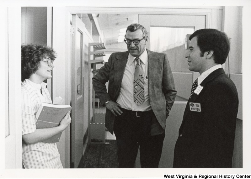Congressman Nick Rahall II speaking with an unidentified man and woman from Union Carbide.