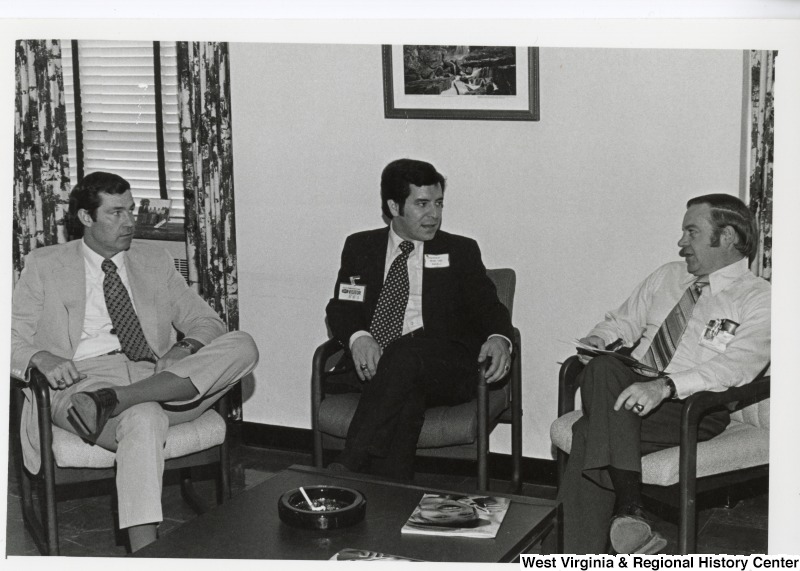 Congressman Nick Rahall II (center) speaking with two unidentified men from Union Carbide.