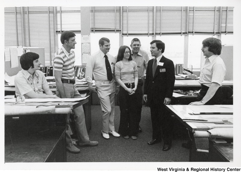 Congressman Nick Rahall II (second from the right) speaking with an unidentified group of people from Union Carbide.