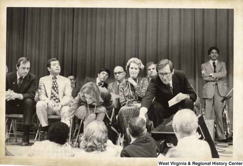 From row left to right: State Treasurer Larrie Bailey; Congressman Nick Rahall (D-WV); Mrs. Sharon Rockefeller; Mrs. Blanchette Rockefeller; Governor John (Jay) D. Rockefeller IV. Second row left to right: Delegate Sammy Dalton; Sheriff Vernon Drigess?; Delegate Charles Gilliam; and Senate elect Earl Ray Tomblin (standing). They are in Logan, WV for a Democratic Rally to re-elect Governor Jay Rockefeller for another term.