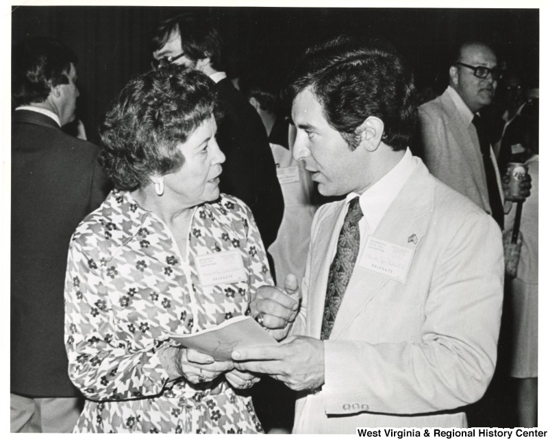 Congressman Nick Rahall II speaking to an unidentified woman.