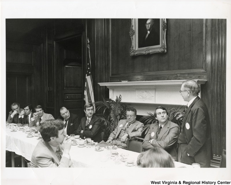 Congressman Nick Rahall II (second from the left) and Senator Jennings Randolph (fourth from the left) at a meeting with seven unidentified men.