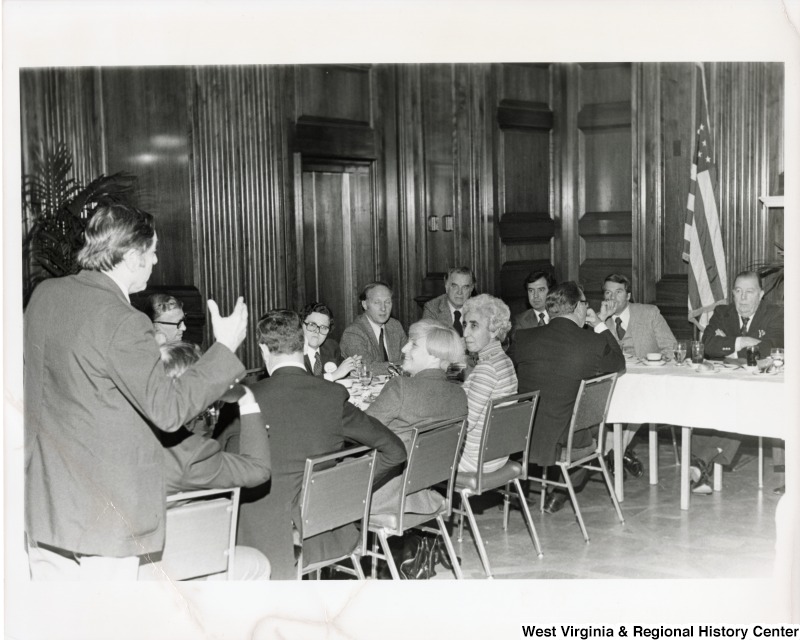 Senator Jennings Randolph (first on the right) and Congressman Nick Rahall II (third from the right) with a unidentified group of people at a meeting.
