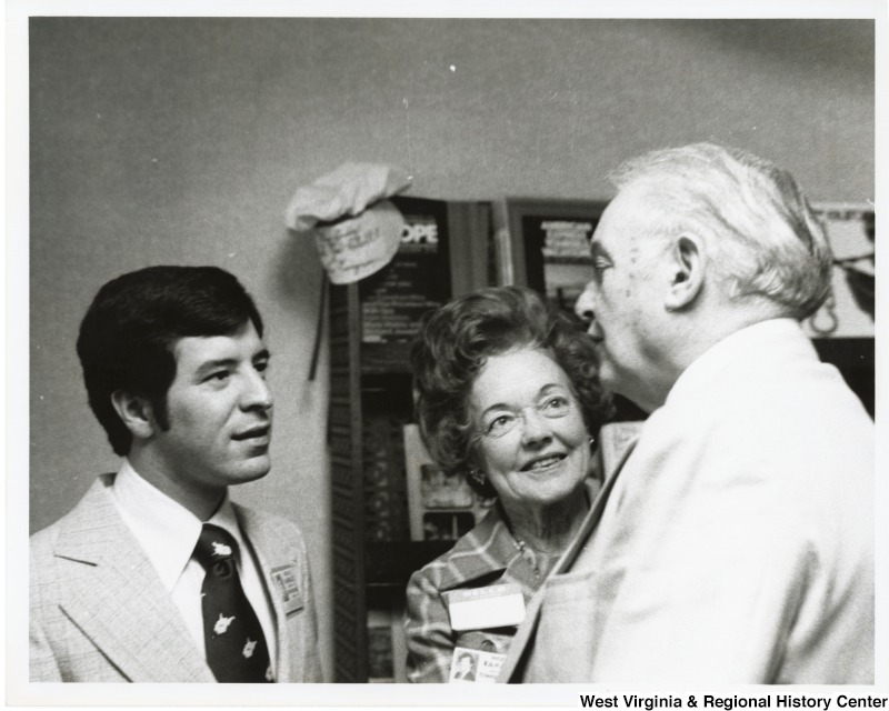 Congressman Nick Rahall II and Odessa Lewis speaking to an unidentified man.