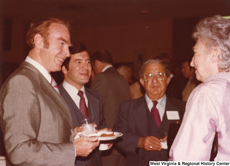 From left to right: an unidentified man; Congressman Nick Rahall II; Nick Rahall, Congressman Rahall's father; and an unidentified woman. They are at Congressman Rahall's 30th birthday fundraising party.