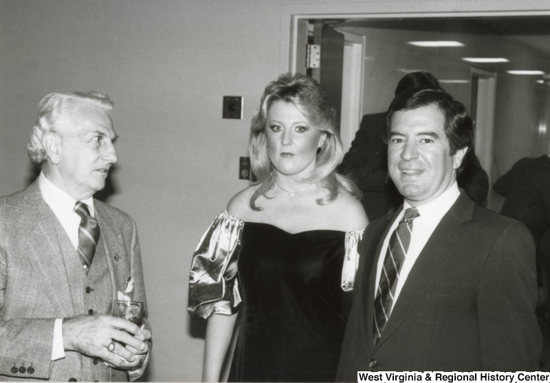 Congressman Nick Rahall II (right) with an unidentified man and woman at one of his birthday parties.