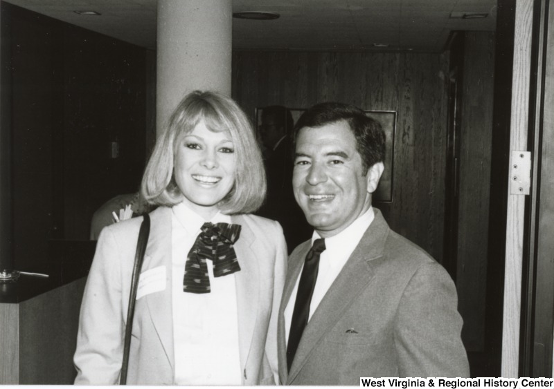 Congressman Nick Rahall II standing with an unidentified woman at his birthday party.