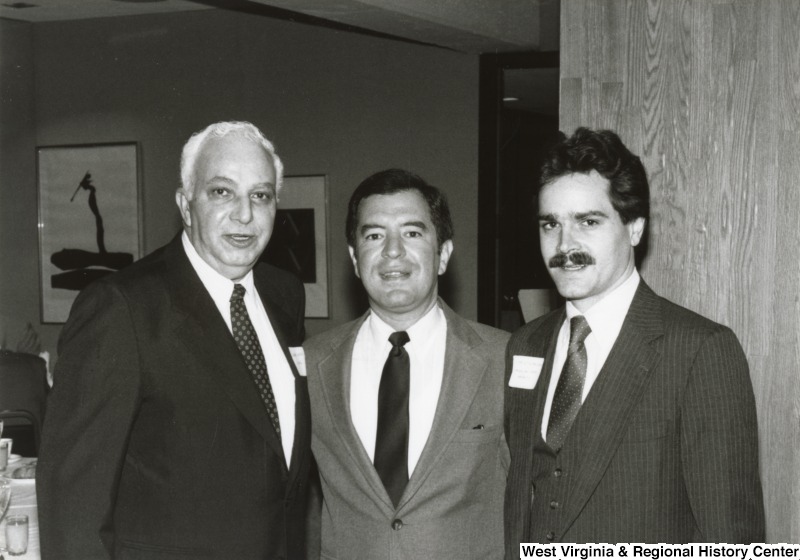 Congressman Nick Rahall II (center) with two unidentified men at his birthday party.