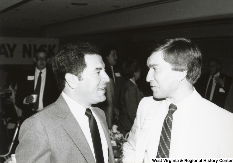 Congressman Nick Rahall II (left) speaking to an unidentified man at his birthday party.