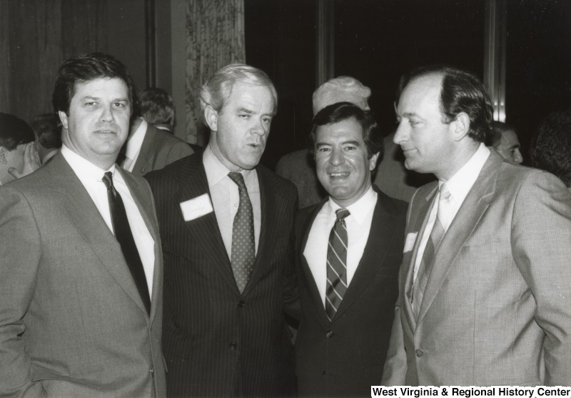Congressman Nick Rahall II (second from the right) with three unidentified men at his birthday party.