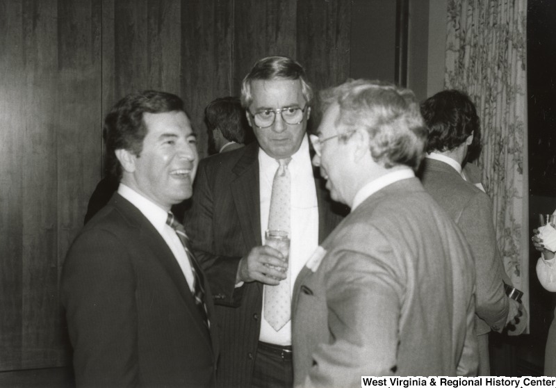 Congressman Nick Rahall II (left) speaking with two unidentified men at his birthday party.