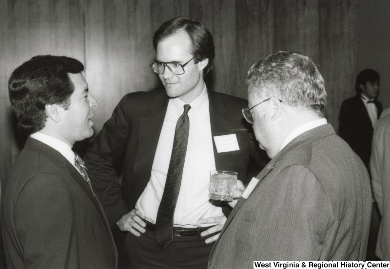 Congressman Nick Rahall II (left) speaking with two unidentified men at his birthday party.