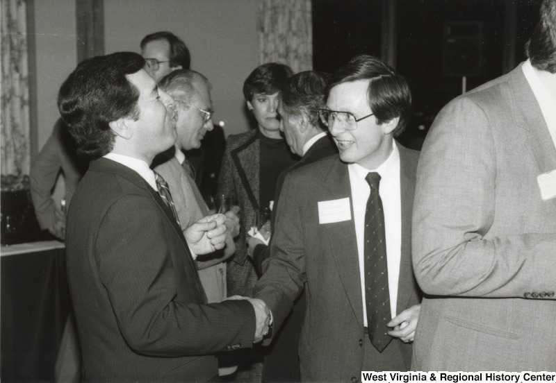 Congressman Nick Rahall II (left) shaking the hand of an unidentified man at his birthday party.