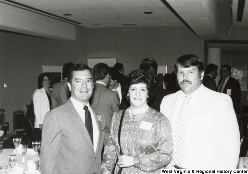 Congressman Nick Rahall II (left) with an unidentified man and woman at his birthday party.