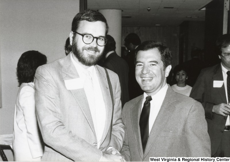 Congressman Nick Rahall II (right) shaking the hand of an unidentified man at his birthday party.