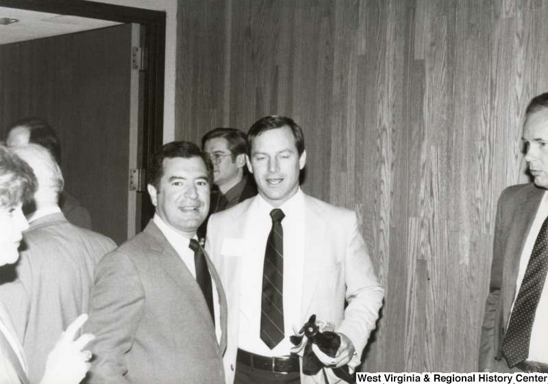 Congressman Nick Rahall II (left) standing with an unidentified man at his birthday party.
