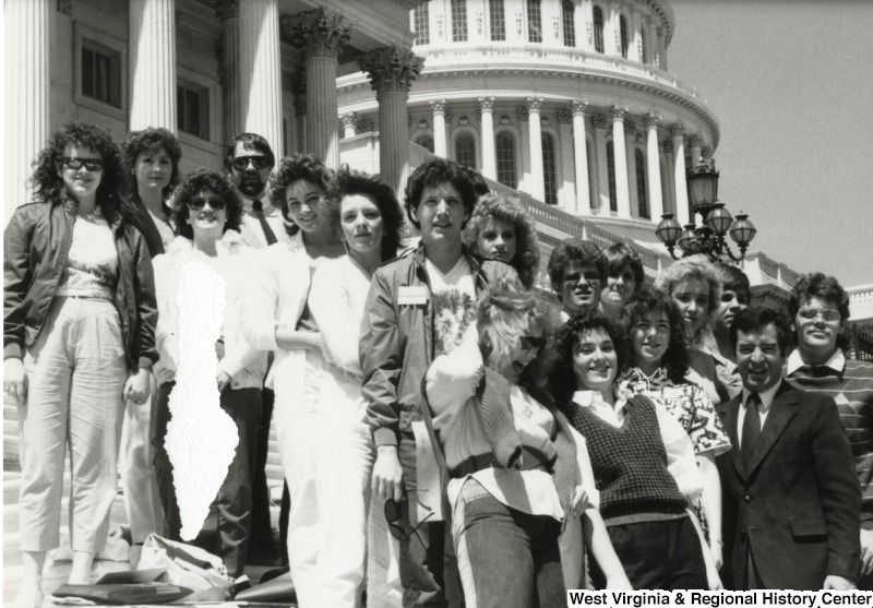 Congressman Nick Rahall II (front right corner) with an unidentified group of men and woman on the steps of the capitol building.