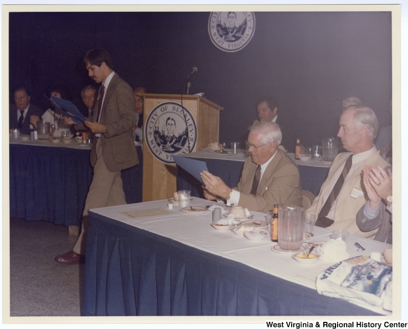 Senators Jennings Randolph (left in back row) and Robert C. Byrd (third from left in back row) as well as Congressman Nick Rahall, II (second from right in back row) at a banquet following the groundbreaking of the Beckley Sewage Treatment plant.