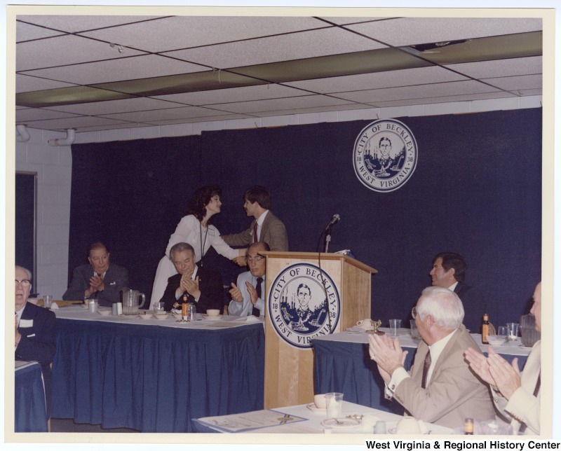 Senators Jennings Randolph (left in back row) and Robert C. Byrd (third from left in back row) as well as Congressman Nick Rahall, II (right in back row) at a banquet following the groundbreaking of the Beckley Sewage Treatment plant.