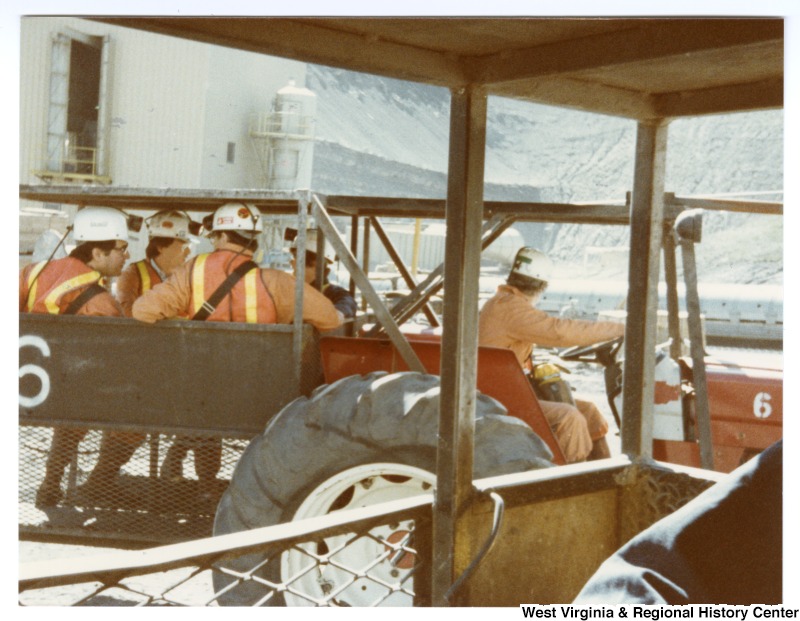 Congressman Nick Rahall, II (left) with an unidentified group of people riding in a work vehicle at Rocky Mountain Energy Company in Wyoming.