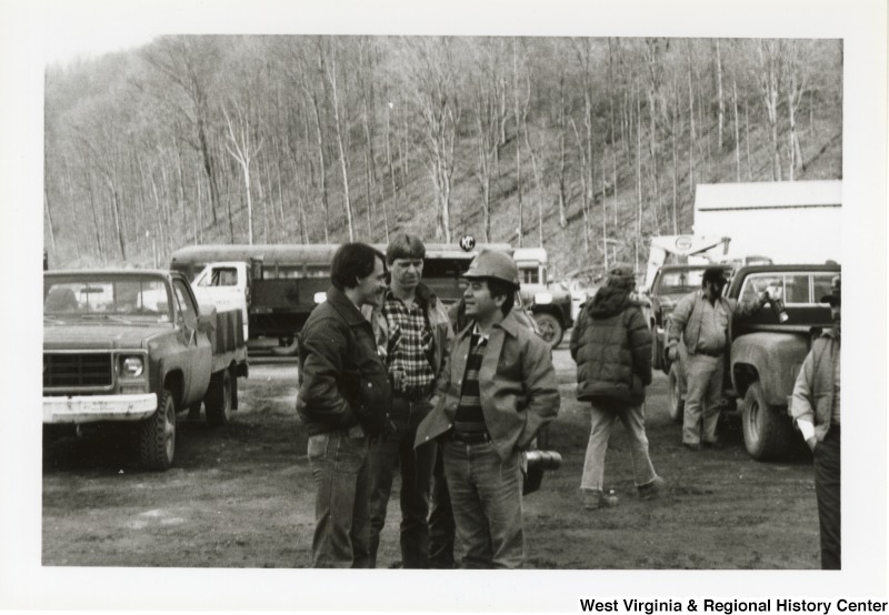 Congressman Nick Rahall, II (third from left) speaking to two unidentified men during his visit of the Hobet Coal Mine.